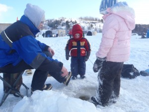 Kids peer down the hole on Parry Sound Harbour